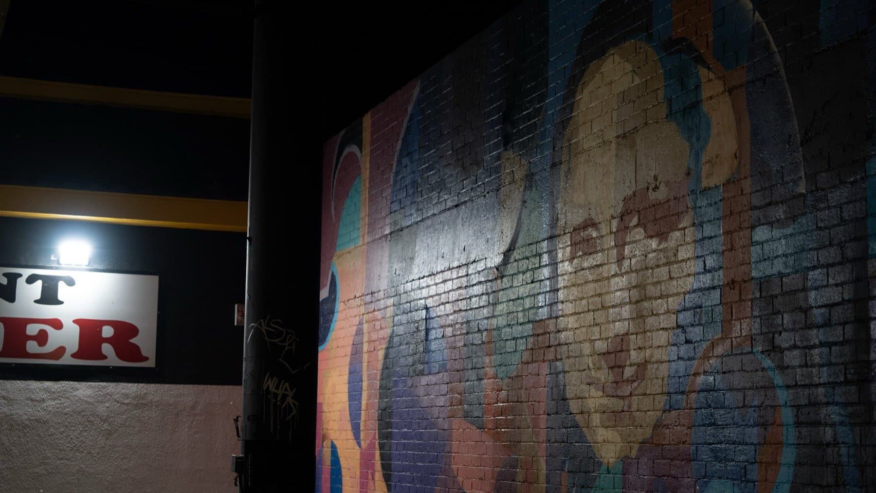 A mural-lined Arts District alley at night