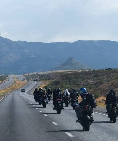 A pack of sportbikes heading down the highway toward the mountains