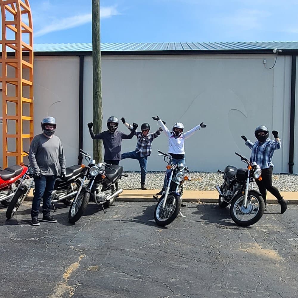 Riders posing with their bikes at a group meetup