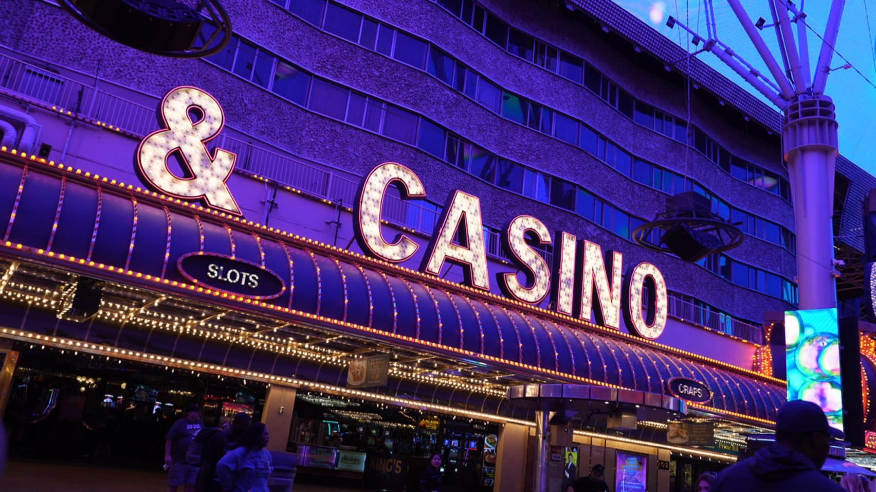 Neon '& Casino' sign glowing on Fremont Street at night