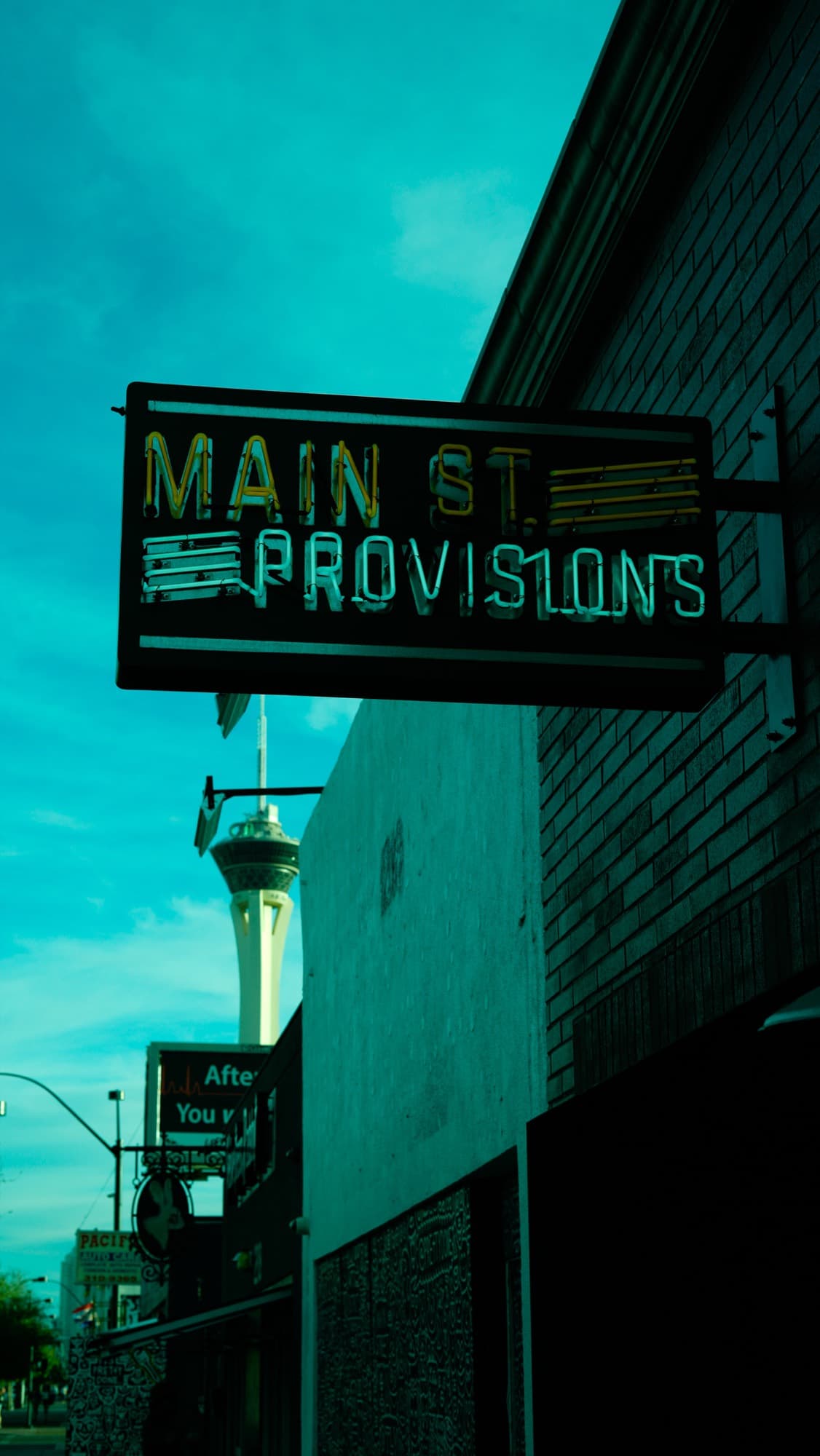The Main St. Provisions neon sign with the Stratosphere beyond