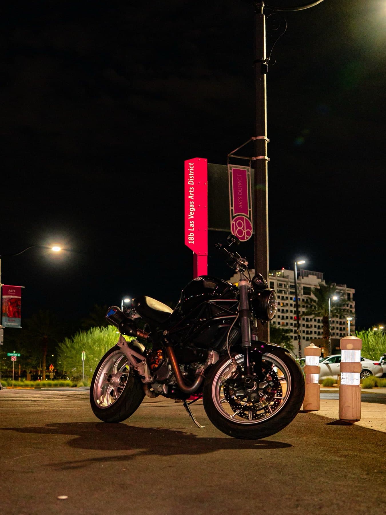 A motorcycle parked in the Las Vegas Arts District at night